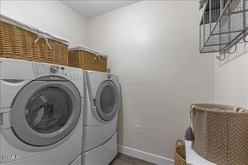 22150 Buena Vista St, Tehachapi, CA 93561 - laundry room featuring washing machine and clothes dryer and wood finished floors
