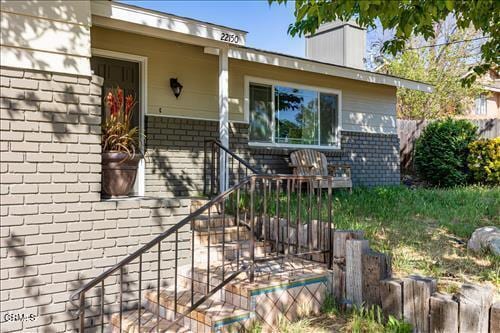 22150 Buena Vista St, Tehachapi, CA 93561 - view of exterior entry featuring brick siding