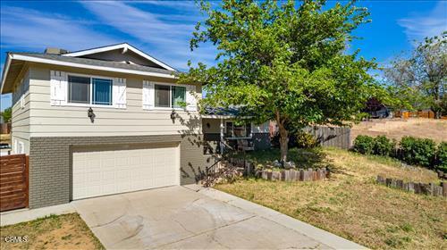 22150 Buena Vista St, Tehachapi, CA 93561 - view of front of house featuring concrete driveway, a garage, and brick siding