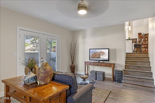 22150 Buena Vista St, Tehachapi, CA 93561 - living area featuring wood finished floors, french doors, a ceiling fan, and stairs