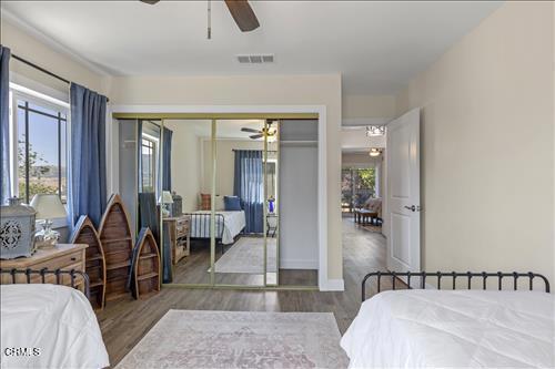 22150 Buena Vista St, Tehachapi, CA 93561 - bedroom featuring wood finished floors, a closet, and ceiling fan