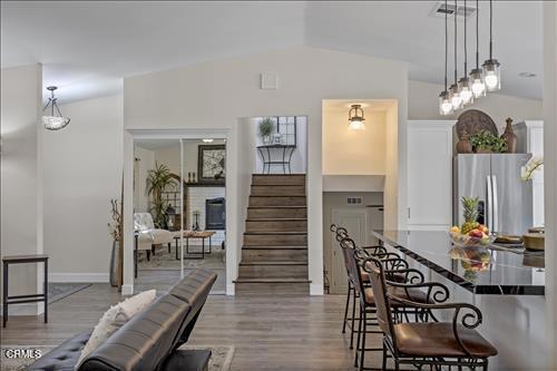 22150 Buena Vista St, Tehachapi, CA 93561 - dining area with stairs, light wood finished floors, and vaulted ceiling