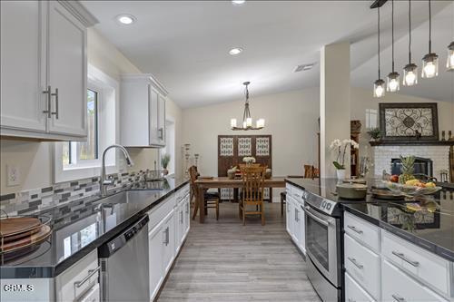 22150 Buena Vista St, Tehachapi, CA 93561 - kitchen featuring stainless steel appliances, a chandelier, tasteful backsplash, white cabinetry, and recessed lighting