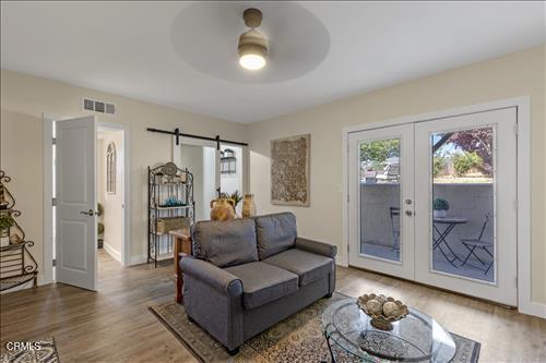22150 Buena Vista St, Tehachapi, CA 93561 - living area featuring french doors, wood finished floors, a ceiling fan, and a barn door