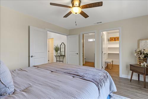 22150 Buena Vista St, Tehachapi, CA 93561 - bedroom with wood finished floors, a walk in closet, and a ceiling fan