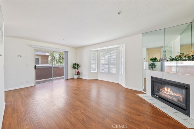 1707 Pepper St Unit A, Alhambra, CA 91801 - unfurnished living room with wood finished floors, a fireplace, and baseboards