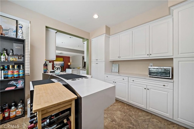 4127 Poplar Cir, Lake Elsinore, CA 92530 - kitchen featuring white cabinets, light countertops, recessed lighting, and light tile patterned floors