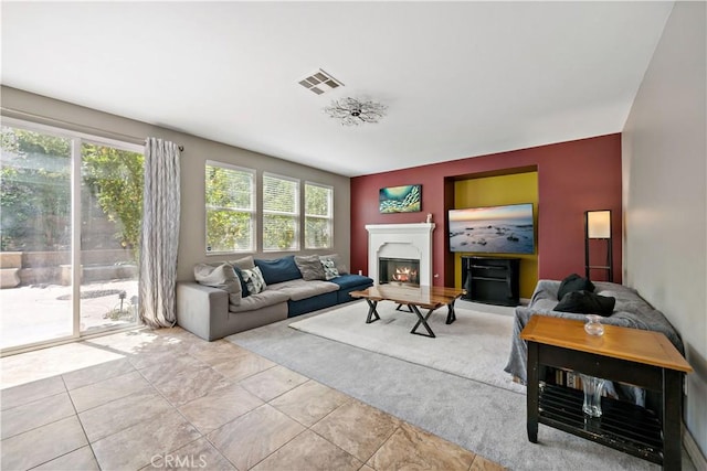 4127 Poplar Cir, Lake Elsinore, CA 92530 - living room with a warm lit fireplace and tile patterned flooring