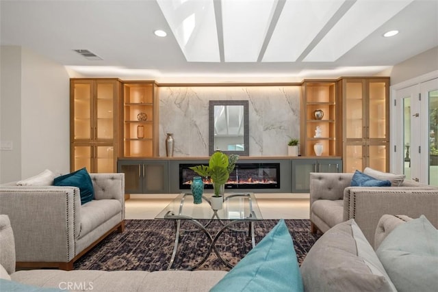 5437 Via Carrizo, Laguna Woods, CA 92637 - living area with a skylight, recessed lighting, and a glass covered fireplace