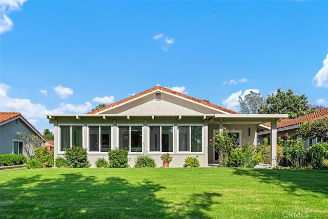 5437 Via Carrizo, Laguna Woods, CA 92637 - rear view of property featuring a lawn and stucco siding