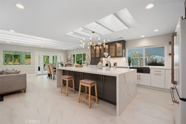 5437 Via Carrizo, Laguna Woods, CA 92637 - kitchen featuring open floor plan, a large island with sink, recessed lighting, a chandelier, and light stone counters