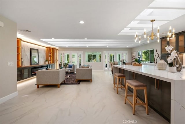 5437 Via Carrizo, Laguna Woods, CA 92637 - living room featuring a chandelier, light marble finish floors, recessed lighting, baseboards, and french doors