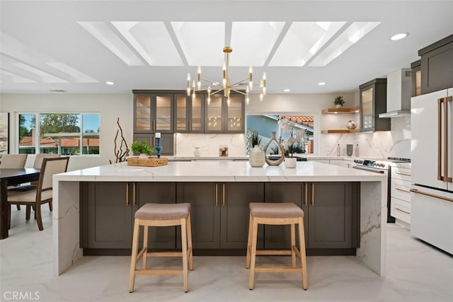 5437 Via Carrizo, Laguna Woods, CA 92637 - kitchen featuring electric range, wall chimney exhaust hood, freestanding refrigerator, tasteful backsplash, and recessed lighting