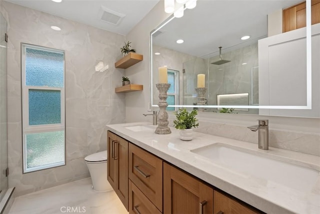 5437 Via Carrizo, Laguna Woods, CA 92637 - bathroom featuring toilet, double vanity, a marble finish shower, marble finish floors, and recessed lighting