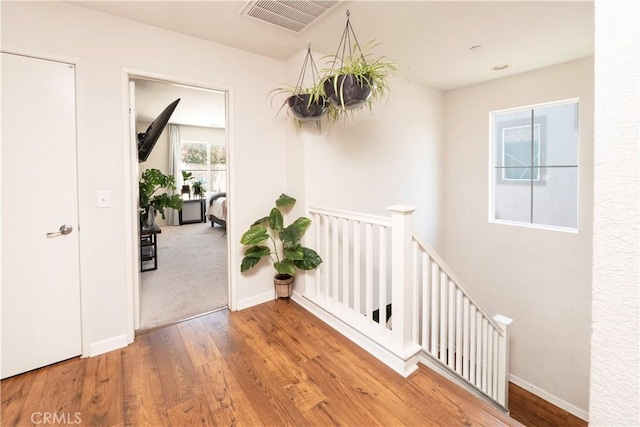 16776 Spy Glass Ct, Fontana, CA 92336 - hallway featuring wood finished floors, an upstairs landing, and baseboards
