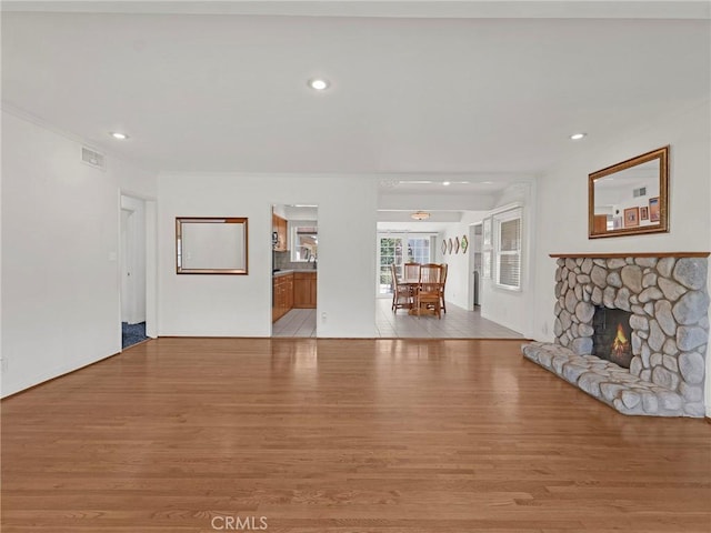 4854 Ranchito Ave, Sherman Oaks, CA 91423 - unfurnished living room with wood finished floors, a stone fireplace, and recessed lighting