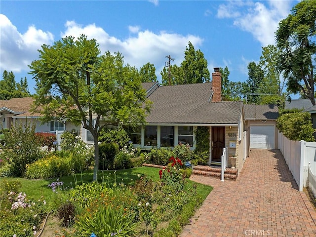 4854 Ranchito Ave, Sherman Oaks, CA 91423 - view of front facade with an attached garage, a chimney, decorative driveway, and a shingled roof