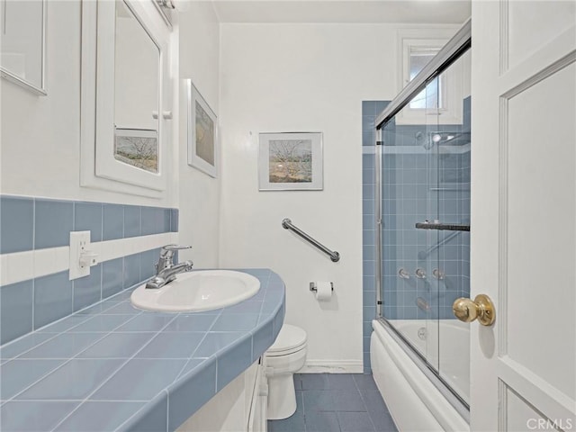 4854 Ranchito Ave, Sherman Oaks, CA 91423 - bathroom featuring vanity, toilet, tile patterned flooring, shower / bath combination with glass door, and baseboards