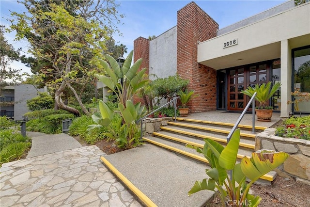 3605 W Hidden Ln Unit 307, Rolling Hills Estates, CA 90274 - property entrance featuring french doors, a chimney, and stucco siding