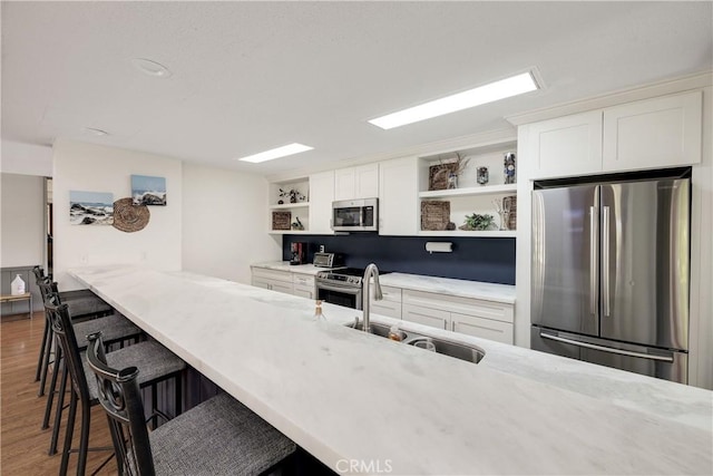 3605 W Hidden Ln Unit 307, Rolling Hills Estates, CA 90274 - kitchen with stainless steel appliances, open shelves, a sink, and white cabinets