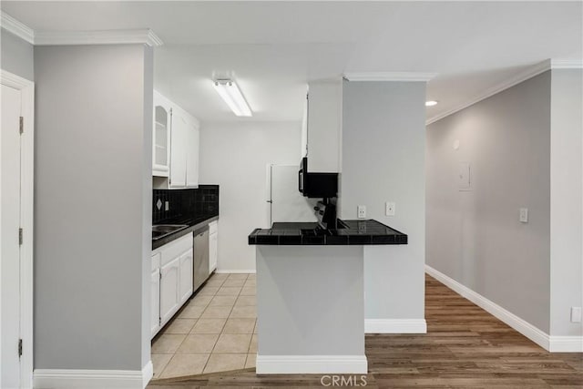 3605 W Hidden Ln Unit 307, Rolling Hills Estates, CA 90274 - kitchen with crown molding, white cabinets, backsplash, tile countertops, and dishwasher