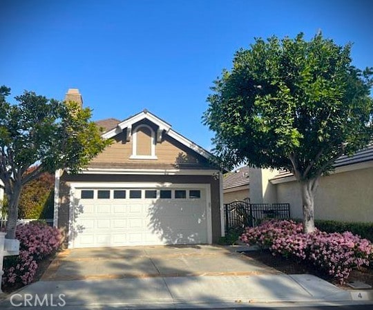 4 Amherst, Laguna Niguel, CA 92677 - view of front of home with concrete driveway, an attached garage, and stucco siding