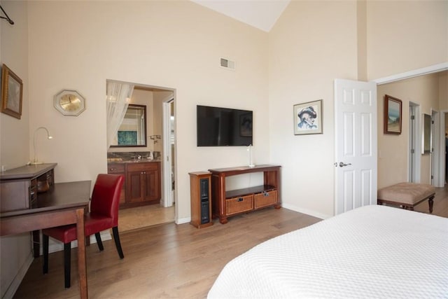 4 Amherst, Laguna Niguel, CA 92677 - bedroom with high vaulted ceiling, light wood-style floors, and ensuite bath