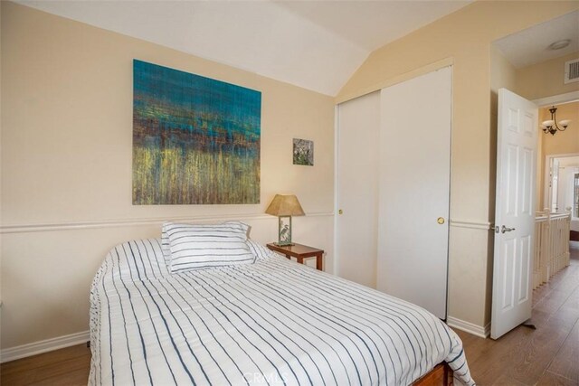 4 Amherst, Laguna Niguel, CA 92677 - bedroom featuring wood finished floors, baseboards, a closet, and vaulted ceiling