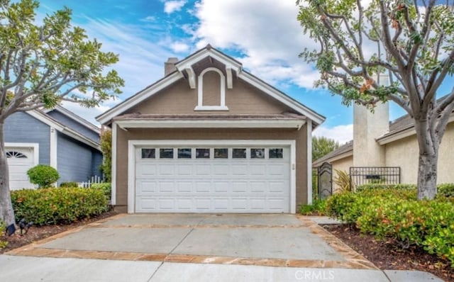 4 Amherst, Laguna Niguel, CA 92677 - view of front of house with a garage, an outbuilding, stucco siding, and a chimney