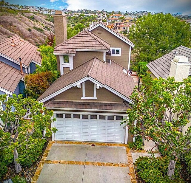 4 Amherst, Laguna Niguel, CA 92677 - traditional-style house featuring a chimney and a garage