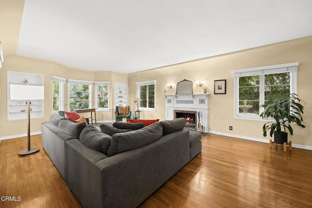 346 Stedman Pl, Monrovia, CA 91016 - living area with wood finished floors, a fireplace, and healthy amount of natural light