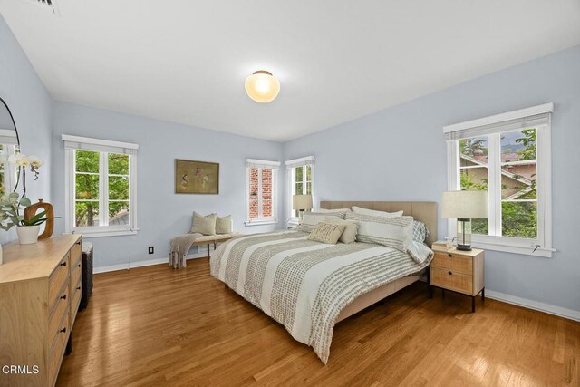 346 Stedman Pl, Monrovia, CA 91016 - bedroom featuring wood finished floors and multiple windows