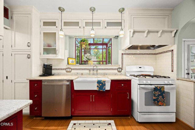 346 Stedman Pl, Monrovia, CA 91016 - kitchen with stainless steel dishwasher, white range with gas stovetop, wood finished floors, and backsplash