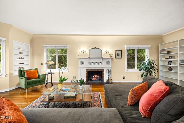 346 Stedman Pl, Monrovia, CA 91016 - living area with wood finished floors, a brick fireplace, plenty of natural light, and built in features