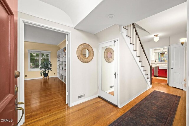 346 Stedman Pl, Monrovia, CA 91016 - entryway featuring wood finished floors, stairway, and vaulted ceiling