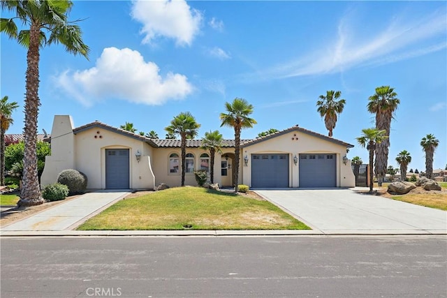 13045 Ridgewood Way, Chowchilla, CA 93610 - mediterranean / spanish-style house featuring stucco siding, a garage, a front yard, and concrete driveway