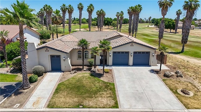 13045 Ridgewood Way, Chowchilla, CA 93610 - mediterranean / spanish home with a tiled roof, stucco siding, an attached garage, and driveway