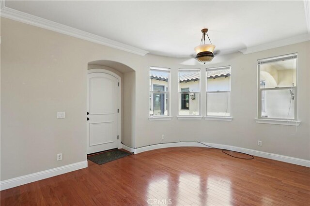 13045 Ridgewood Way, Chowchilla, CA 93610 - unfurnished room featuring ornamental molding, wood finished floors, arched walkways, and baseboards