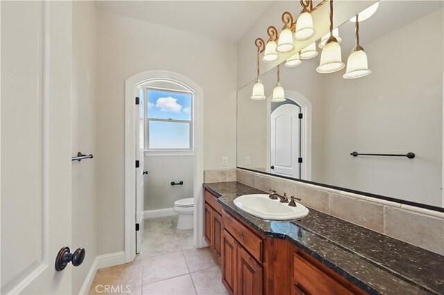 13045 Ridgewood Way, Chowchilla, CA 93610 - bathroom featuring vanity, toilet, tile patterned floors, and baseboards