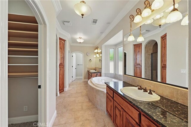 13045 Ridgewood Way, Chowchilla, CA 93610 - full bath with two vanities, a garden tub, crown molding, and a spacious closet