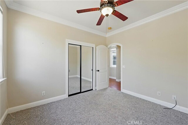 13045 Ridgewood Way, Chowchilla, CA 93610 - unfurnished bedroom with carpet, crown molding, arched walkways, baseboards, and a closet