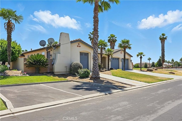 13045 Ridgewood Way, Chowchilla, CA 93610 - mediterranean / spanish-style house with stucco siding, an attached garage, and a tile roof