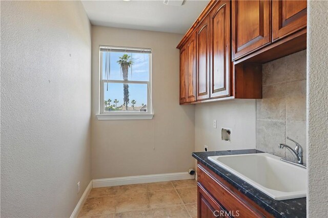 13045 Ridgewood Way, Chowchilla, CA 93610 - laundry room featuring hookup for a washing machine, cabinet space, baseboards, electric dryer hookup, and light tile patterned floors