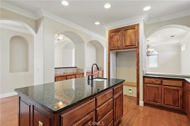 13045 Ridgewood Way, Chowchilla, CA 93610 - kitchen with a sink, light wood-type flooring, dark stone counters, a center island with sink, and recessed lighting