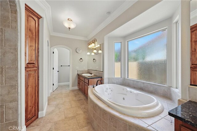 13045 Ridgewood Way, Chowchilla, CA 93610 - bathroom featuring vanity, a whirlpool tub, ornamental molding, baseboards, and stone finish flooring