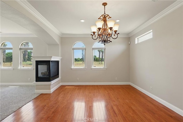 13045 Ridgewood Way, Chowchilla, CA 93610 - unfurnished living room with light wood-style floors, baseboards, a chandelier, ornamental molding, and a multi sided fireplace
