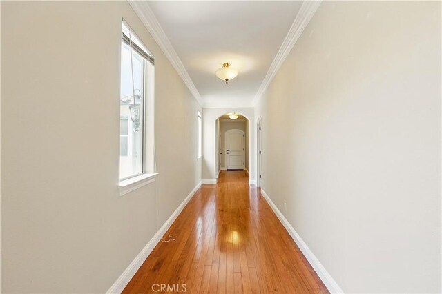 13045 Ridgewood Way, Chowchilla, CA 93610 - corridor featuring arched walkways, light wood-type flooring, ornamental molding, and baseboards