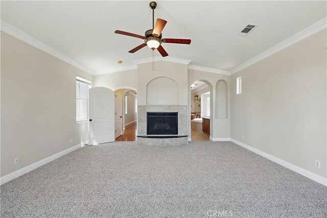 13045 Ridgewood Way, Chowchilla, CA 93610 - unfurnished living room with arched walkways, crown molding, a ceiling fan, light carpet, and baseboards