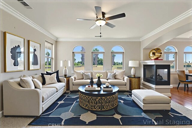 13045 Ridgewood Way, Chowchilla, CA 93610 - living room with healthy amount of natural light, ornamental molding, ceiling fan, and wood finished floors