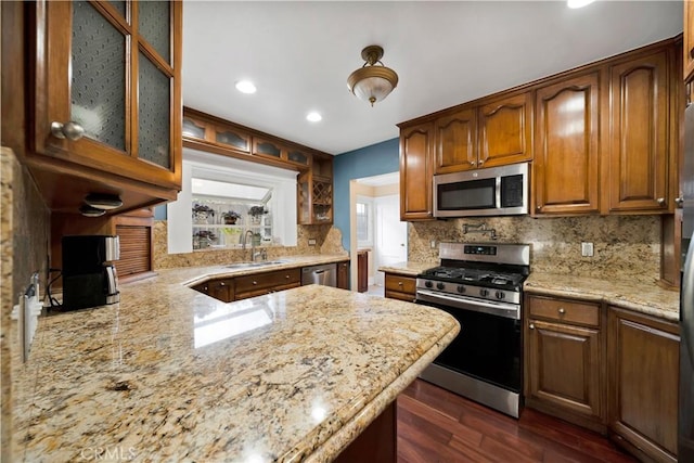 1914 S W View St, Los Angeles, CA 90016 - kitchen featuring stainless steel appliances, a sink, backsplash, dark wood finished floors, and light stone countertops